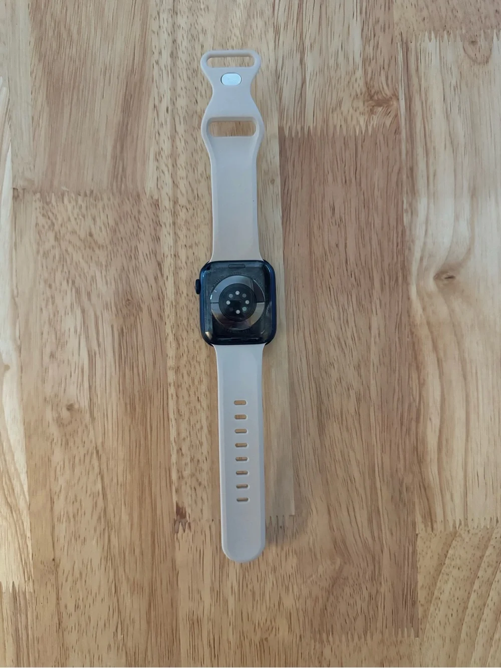 Apple Smartwatch with Light Beige Silicone Band and Black Face